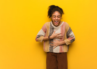 Young black african american girl with blue eyes laughing and having fun