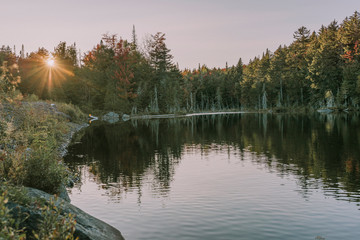 Kayaking in Boreas Ponds in the Adirondacks on a glassy lake with Mount Marcy and the high peaks in...