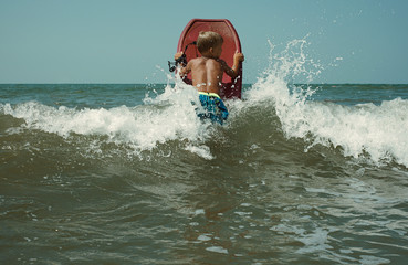 Naklejka premium Boy jumping with bodyboard
