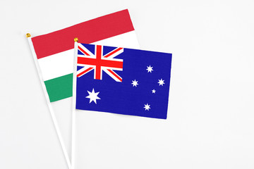 Fototapeta premium Australia and Hungary stick flags on white background. High quality fabric, miniature national flag. Peaceful global concept.White floor for copy space.