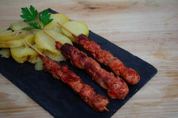 Pinchos morunos  or meat skewer. Typical Spanish cuisine dish made with pork or chicken carn marinated with garlic and paprika