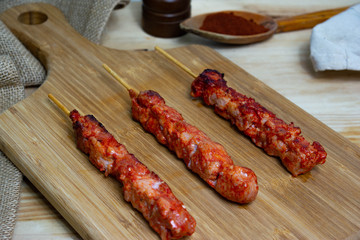 Pinchos morunos  or meat skewer. Typical Spanish cuisine dish made with pork or chicken carn marinated with garlic and paprika