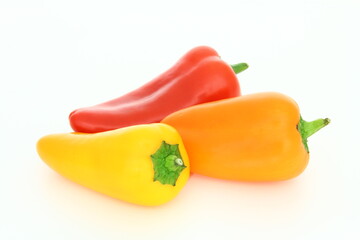 Fresh vegetables - peppers - red, yellow and orange plants on white background - source of vitamin c