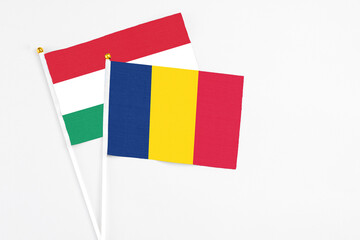 Chad and Hungary stick flags on white background. High quality fabric, miniature national flag....