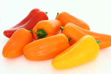 Healthy food - small sweet peppers on white background - vegetables