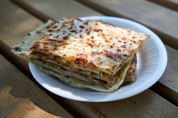 Appetizing crispy turkish tortillas with filling lie on a plate.