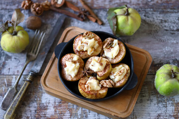 Baked quince with cinnamon and cream cheese. Healthy autumn food. Keto diet. Keto dessert. Selective focus. Macro.