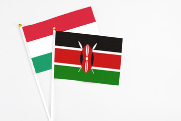 Kenya and Hungary stick flags on white background. High quality fabric, miniature national flag. Peaceful global concept.White floor for copy space.