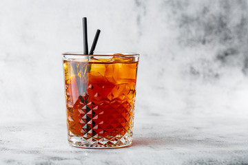 Glasse of iced black tea with lemon, overhead view. isolated on bright marble background. Overhead...