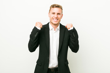 Young caucasian business man cheering carefree and excited. Victory concept.