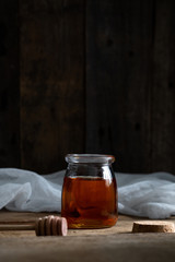 honey cake. jar of honey. hand with a spoon for honey. honey drips from a spoon