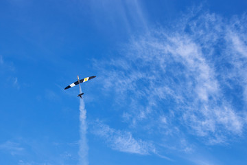 A model of a radio-controlled rocket plane soaring into the sky.