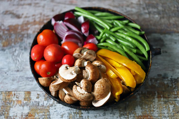 Colored vegetables in a pan before baking. Vegan recipe. Healthy bright food.
