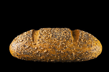 Cereal bread in profile, on black background - obrazy, fototapety, plakaty