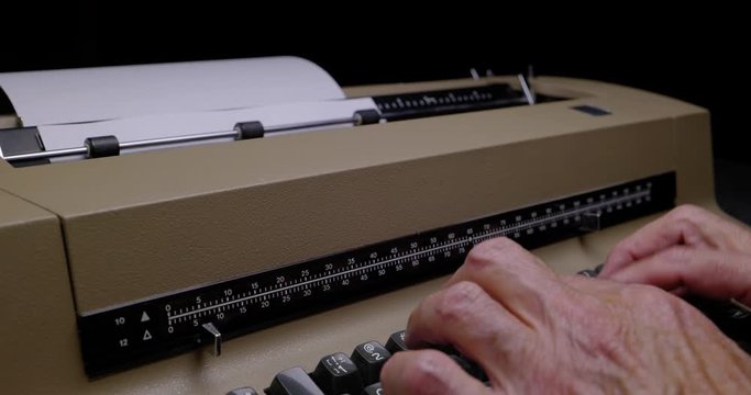 ECU OF MALE HANDS USING A VINTAGE ELECTRIC TYPEWRITER.  C4K, 10 BIT, ALL-INTRA CODEC