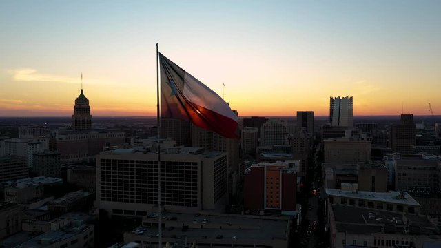 4K San Antonio Skyline Texas State Flag Rising Drone at Sunset Sunrise Dawn