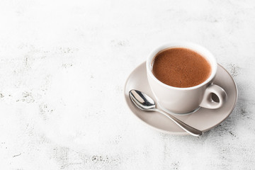 Cup of hot cocoa or hot chocolate or americano in white cup isolated on bright marble background.  Horizontal photo. traditional drinks for winter time