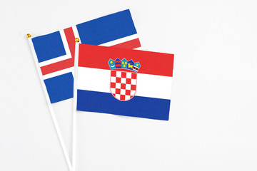 Croatia and Iceland stick flags on white background. High quality fabric, miniature national flag....