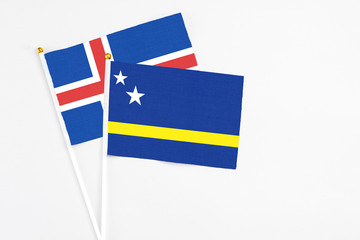 Curacao and Iceland stick flags on white background. High quality fabric, miniature national flag. Peaceful global concept.White floor for copy space.
