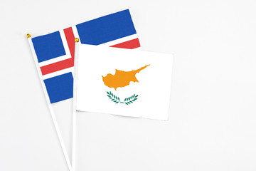 Cyprus and Iceland stick flags on white background. High quality fabric, miniature national flag. Peaceful global concept.White floor for copy space.