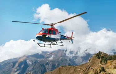 Peel and stick wall murals Helicopter Medical Rescue helicopter landing in high altitude Himalayas mountains. Safety and travel insurance concept image.