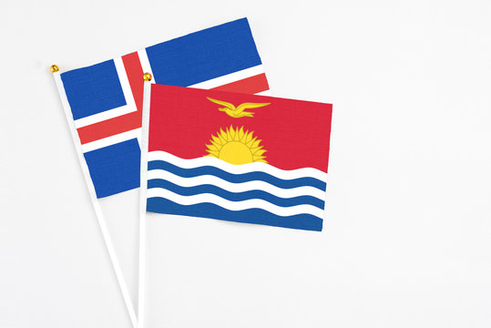 Kiribati and Iceland stick flags on white background. High quality fabric, miniature national flag. Peaceful global concept.White floor for copy space.