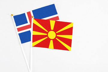 Macedonia and Iceland stick flags on white background. High quality fabric, miniature national flag. Peaceful global concept.White floor for copy space.
