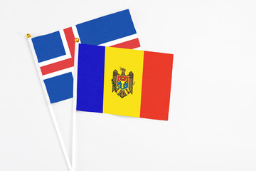 Moldova and Iceland stick flags on white background. High quality fabric, miniature national flag. Peaceful global concept.White floor for copy space.