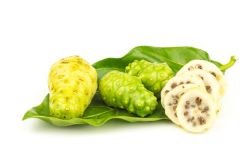 Noni fruit with green leaf on white background.