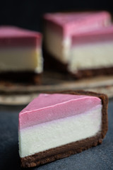 Appetizing slice of cheesecake with pink cream. frozen raspberries