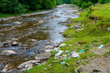 Plastic disaster in wild nature mountain river