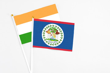 Belize and India stick flags on white background. High quality fabric, miniature national flag. Peaceful global concept.White floor for copy space.
