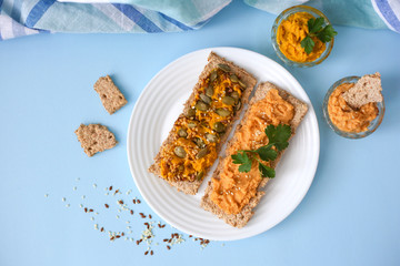 Two hummus sandwiches on a blue background top view. Hummus snacks. Vegan food concept