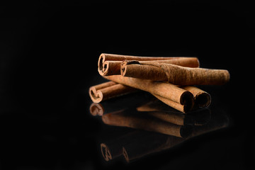 Cinnamon on black mirror background