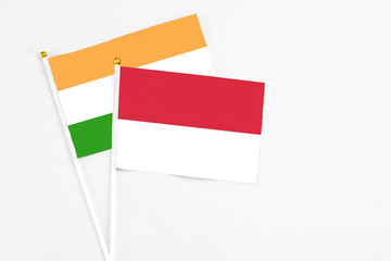 Indonesia and India stick flags on white background. High quality fabric, miniature national flag. Peaceful global concept.White floor for copy space.