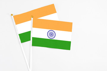 India and India stick flags on white background. High quality fabric, miniature national flag. Peaceful global concept.White floor for copy space.