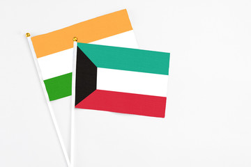 Kuwait and India stick flags on white background. High quality fabric, miniature national flag. Peaceful global concept.White floor for copy space.