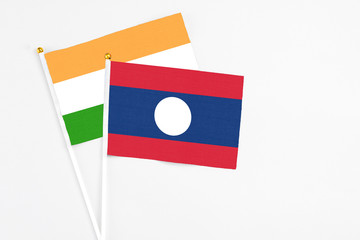 Laos and India stick flags on white background. High quality fabric, miniature national flag. Peaceful global concept.White floor for copy space.