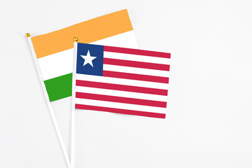 Liberia and India stick flags on white background. High quality fabric, miniature national flag. Peaceful global concept.White floor for copy space.