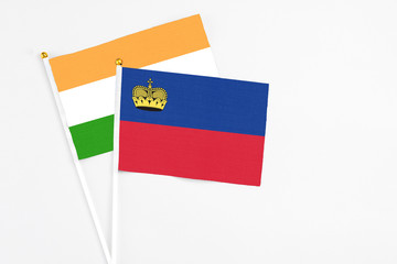 Liechtenstein and India stick flags on white background. High quality fabric, miniature national flag. Peaceful global concept.White floor for copy space.