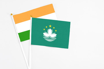 Macao and India stick flags on white background. High quality fabric, miniature national flag. Peaceful global concept.White floor for copy space.