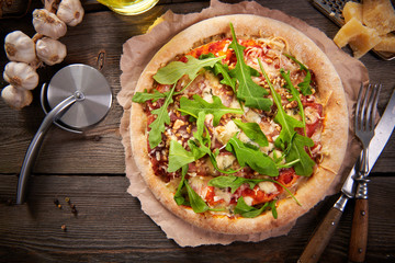 Pizza with prosciutto ham, walnuts, gorgonzola cheese and walnuts