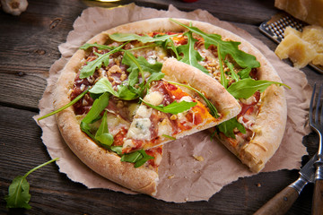 Pizza with prosciutto ham, walnuts, gorgonzola cheese and walnuts