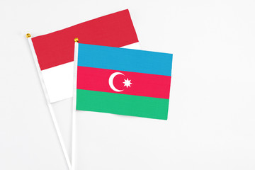 Azerbaijan and Indonesia stick flags on white background. High quality fabric, miniature national flag. Peaceful global concept.White floor for copy space.