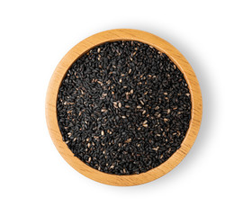 Black Sesame Seeds in a wooden cup on a white background. top view