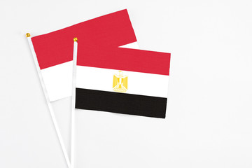Egypt and Indonesia stick flags on white background. High quality fabric, miniature national flag. Peaceful global concept.White floor for copy space.