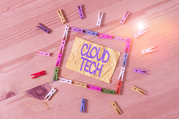 Writing note showing Cloud Tech. Business concept for storing and accessing data and programs over the Internet Colored clothespin papers empty reminder wooden floor background office