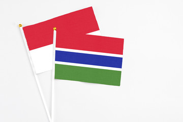 Gambia and Indonesia stick flags on white background. High quality fabric, miniature national flag. Peaceful global concept.White floor for copy space.