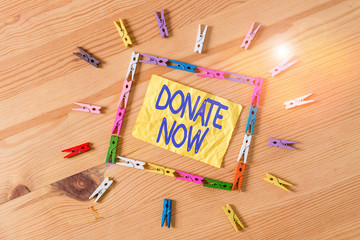 Writing note showing Donate Now. Business concept for to give something like money or goods to a...
