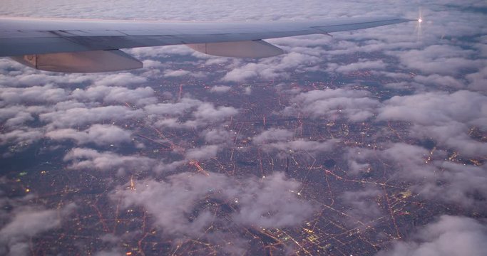 Aerial View of Paris Through Clouds at Sunset, France